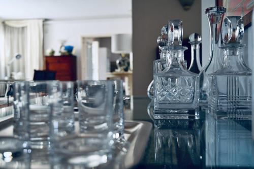 a group of glass bottles and glasses sitting on a sink at Aura Relais in Numana
