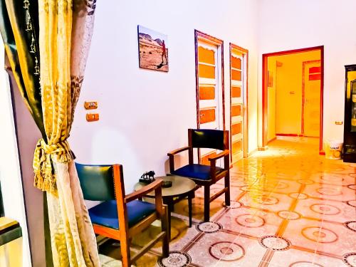 a room with chairs and a table and a door at Safari Abu Simbel in Abu Simbel