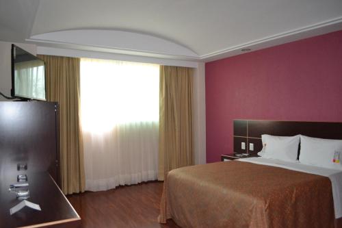 Säng eller sängar i ett rum på Hotel & Villas Panamá
