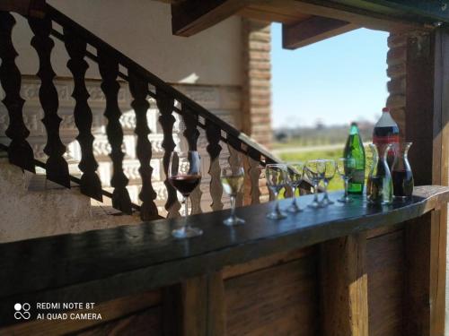 a railing with wine glasses and bottles on it at Apartman - Vinska Cesta in Ðurđevac