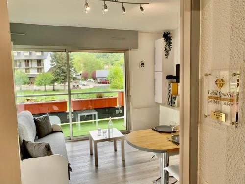 a living room with a couch and a table at Gîte 3*** Le Chardon Bleu in Saint-Lary-Soulan