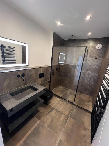 a bathroom with a sink and a shower at Dyke Appartements in Büsum