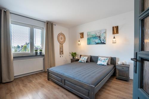 a bedroom with a bed and a window at Apartament Nad Różami in Oświęcim