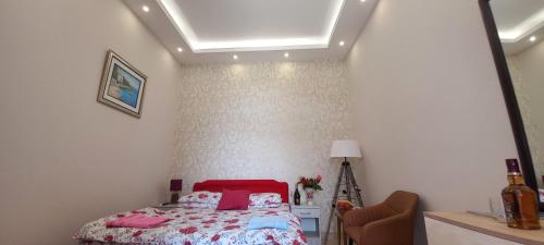 a bedroom with a bed with pink pillows at Aпартаменты Влаович in Igalo