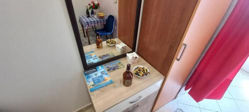 a bathroom with a counter with a mirror and a sink at Aпартаменты Влаович in Igalo