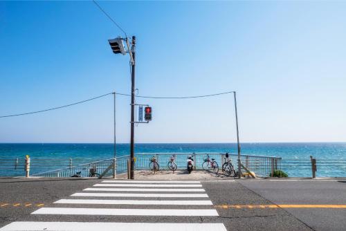 a group of people riding bikes on the beach at BIRD HOTEL in Kamakura