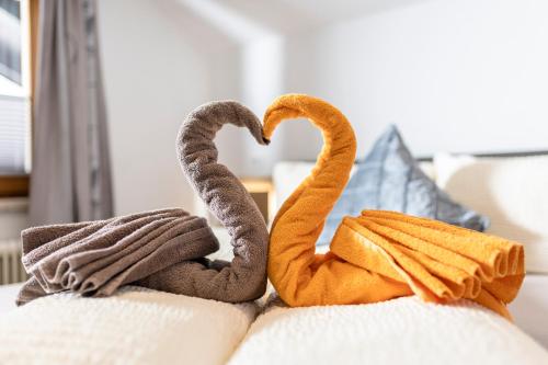 two towel animals sitting on top of a couch at AlpenLiving in Mayrhofen