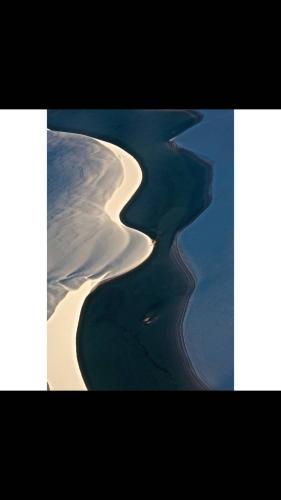 an aerial view of the ocean and the coast at Casa de Atins in Atins