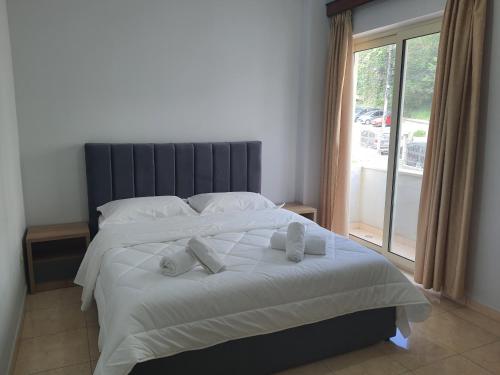 a bedroom with a large bed with towels on it at Villa Olympia in Durrës