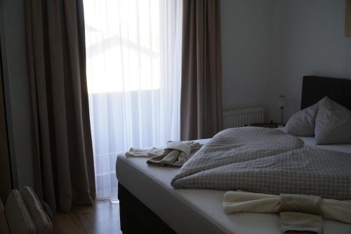 a bedroom with a bed and a large window at Pension-Ferienwohnung Rotar in Faak am See