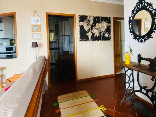 a room with a bed and a table and a mirror at BEACH-SURF house in Moledo