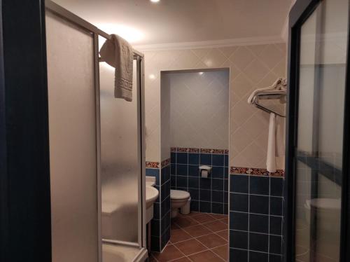 a bathroom with a toilet and a glass shower at Belle Vue Ölüdeniz in Fethiye
