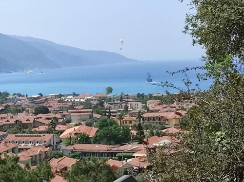 a town with houses and the water in the background at Belle Vue Ölüdeniz in Fethiye
