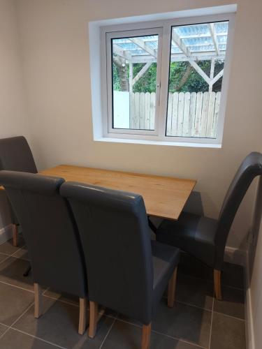 a dining room table with two chairs and a window at 8 Eyre Square Lane in Galway
