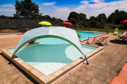 a swimming pool with a tent around it at Le Hibou @ Le Prielle in Madiran