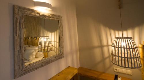 a mirror in a room with a lamp and a table at The Olive Yard in Gythio
