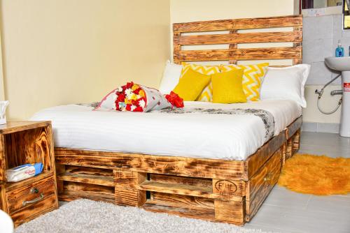 a bedroom with a bed made out of wood at Ruby Modern Homes Studio Apt-Imara Daima Behind Imaara Mall-JKIA-Nebula in Nairobi