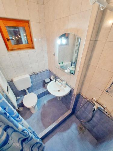 a bathroom with a sink and a toilet and a mirror at Lazy Bear in Plitvička Jezera