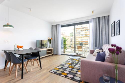 a living room with a couch and a table at Caleyro Boutique Apartments - "Parking incluido" in Fuengirola