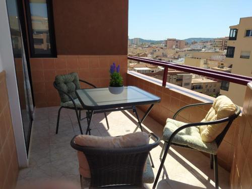 a table and chairs on a balcony with a view at Las Palmeras, 893 in Fuengirola