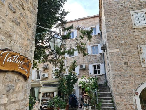 a stone building with stairs in front of it at Beatrix Suites in Budva