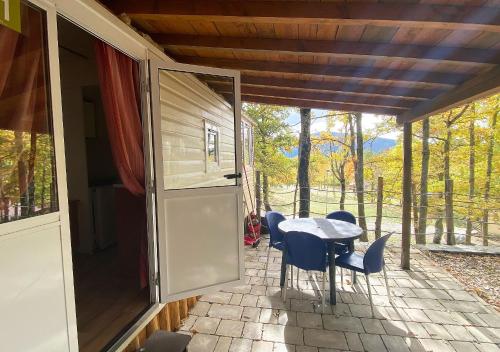 a screened in porch with a table and chairs at Camping Village la Verna in Chiusi della Verna