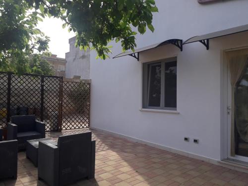 a white house with a fence and a patio at Casa Vacanza Campoli in Ruffano