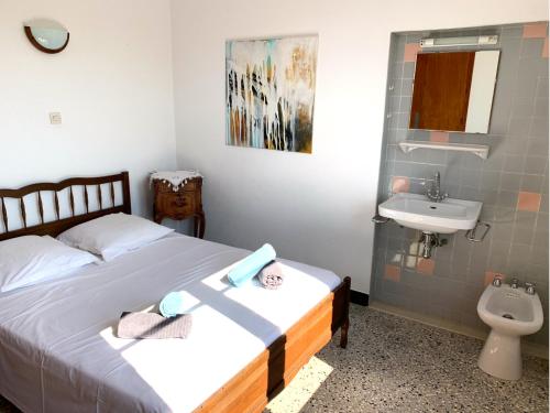 a small bedroom with a bed and a sink at Villa Provençale avec vue mer panoramique in Le Lavandou