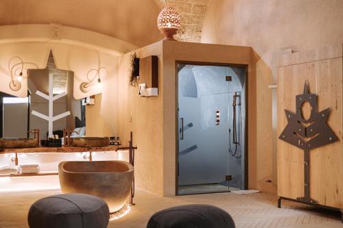 a room with a door and two stools and a mirror at Agriresort Murciano in Otranto