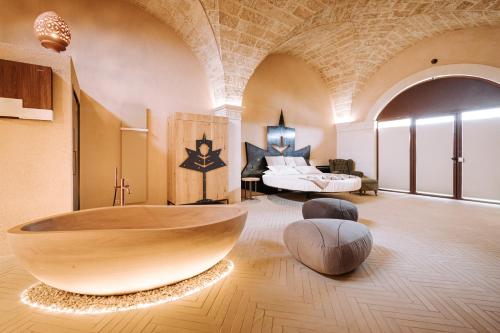 a large bathroom with a large wooden tub in a room at Agriresort Murciano in Otranto