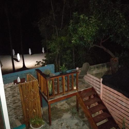 a wooden bench next to a fence at night at Westskye in Saint James