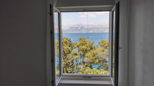 an open window with a view of the ocean at Mira in Splitska