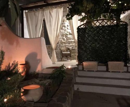 a patio with stairs and a chair in a house at Kelu e Terra - Locazione Turistica - IUN Q0467 in Onifai