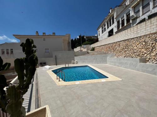 a swimming pool in the middle of a building at Piso Alcosta Piteras in Altea