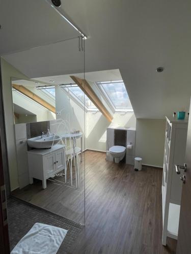 an attic bathroom with a sink and a toilet at Ferienwohnung „Otto Lilienthal“ in Anklam