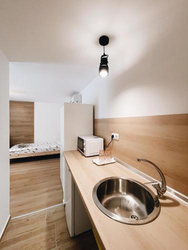 a kitchen with a sink and a bed in a room at Sirena Holiday Park in Kamchia