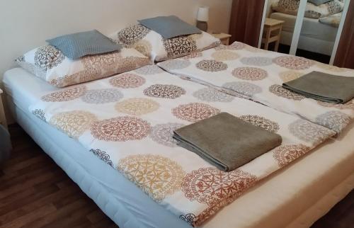 a bed with a blanket and pillows on it at Apartmán s vířivkou a infrasaunou v Olomouci in Olomouc