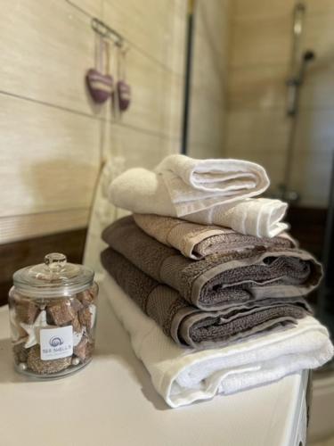 a pile of towels sitting on a counter in a bathroom at Villa OCTOPUS in Dąbki