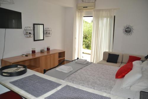 a bedroom with a bed and a desk and a chair at A Place to Relax 2 in Nisakion