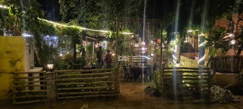 a room with a fence and lights at night at IL Padrino hotel in Pushkar