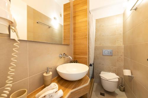a bathroom with a sink and a toilet at Pension Moschoula in Platis Yialos Sifnos