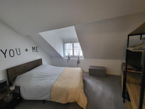 une chambre avec un lit avec les mots toi et moi sur le mur dans l'établissement T2 meublé La Souterraine, à La Souterraine