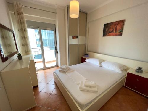 a bedroom with a bed with two towels on it at Saranda Central Apartment in Sarandë