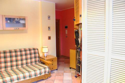 a living room with a couch and a chair at Fiocco di neve, residence Magnola in Ovindoli