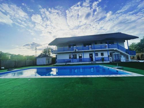 a house with a swimming pool in front of it at Splendoarea Deltei in Maliuc