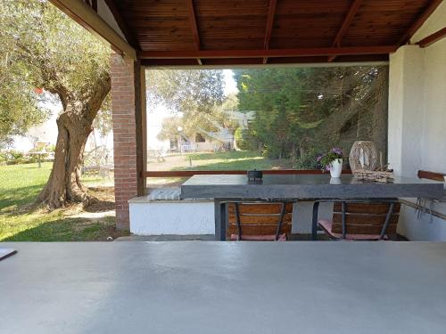 a patio with a table and chairs in a yard at Marios Garden House in Afitos