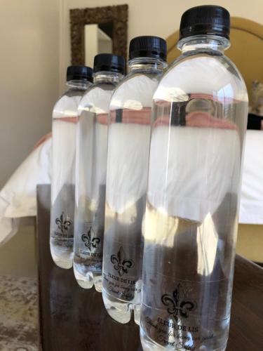 three bottles of water sitting on top of a table at Fleur de Lis Guesthouse in Krugersdorp