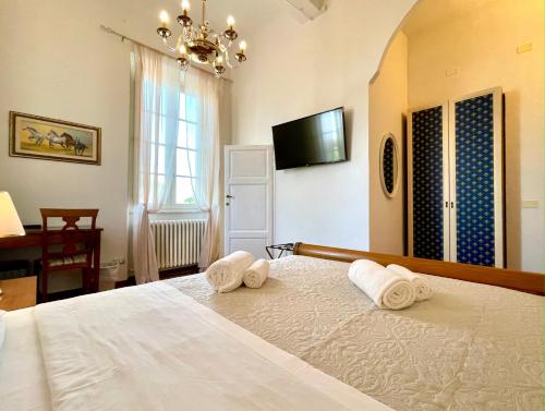 a bedroom with a bed with towels on it at Villa Conti in Fauglia