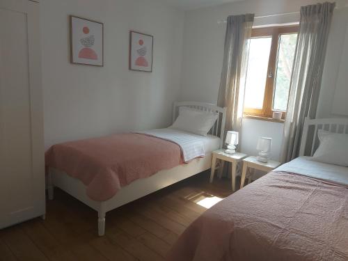 a bedroom with two beds and a window at Apartment Ruza in Starigrad-Paklenica