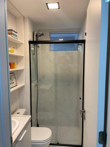 a bathroom with a shower and a toilet at Branco Haus - Pé na Areia do Caribessa in João Pessoa